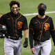Mauricio Dubon and first base coach Alyssa Nakken walk back to the dugout after the seventh inning of the Giants’ exhibition game against the Oakland As on Monday night.